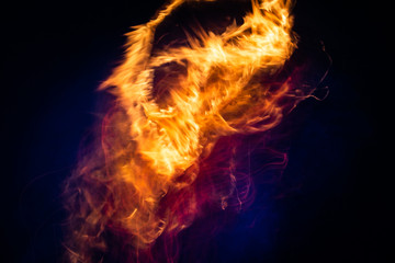 Fototapeta na wymiar fire burns on a dark background