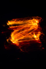 fire burns on a dark background