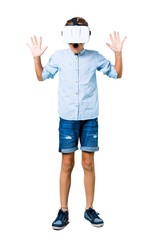 Little kid using VR glasses on isolated white background