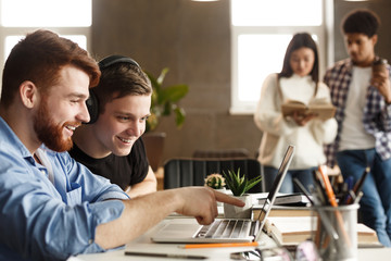 University students at library studying together and connecting online