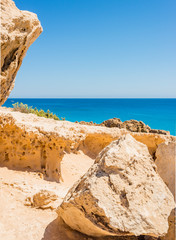  colorful pristine nature of the coast of Cyprus cape cavo greco with clear blue water and yellow rocks