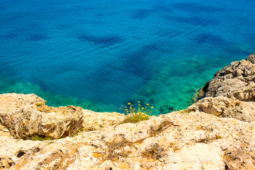  colorful pristine nature of the coast of Cyprus cape cavo greco with clear blue water and yellow rocks