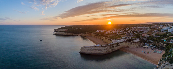 Sunset aerial view on Praia da Senhora da Rocha in the south coast of Algarve destination region, Portugal.