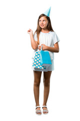 A full-length shot of a Little girl at a birthday party holding a gift bag pointing with the index finger a great idea on isolated white background