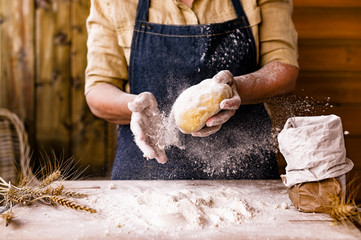 Women's hands, flour and dough. Levitation in a frame of dough and flour. A woman in an apron is...