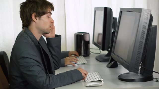 Tired Businessman in Office Trying To Stay Awake