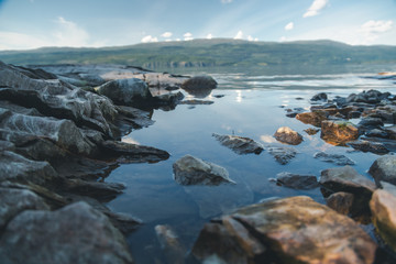 Stones on the shore of the lake, details of nature, soft focus
