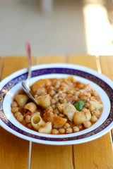 Plate of pasta, chickpea and shrimp stew. Selective focus.