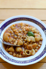 Plate of pasta, chickpea and shrimp stew. Selective focus.