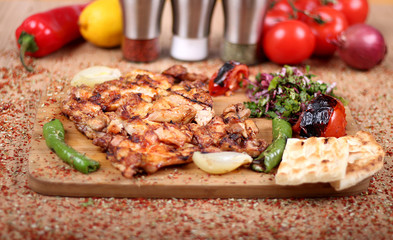 Grilled Chicken Serving on White Plate with Fresh Pepper  on Spicy Wooden Table