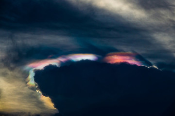 Nature phenomenon, cosmic rainbow sky cloud, nature phenomenon of sun light against storm clouds.