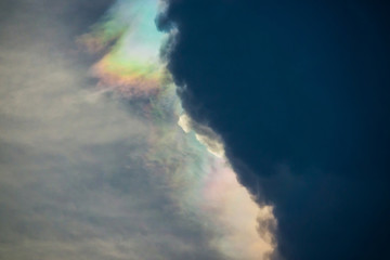 Nature phenomenon, cosmic rainbow sky cloud, nature phenomenon of sun light against storm clouds.