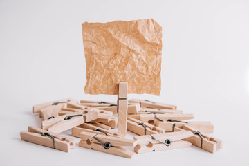 Woodenl clothespins, paper clip and brown sticker on white background. Isolated on white. Place for your text