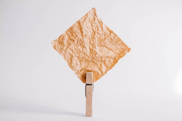 Brown sticker with wooden clothespin isolated on white background. Place for your text