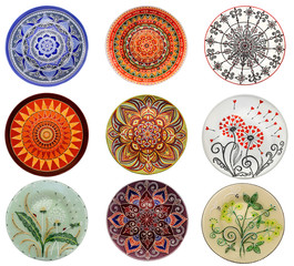 Set of decorative ceramic dishes hand-painted with acrylic paints floral pattern isolated on white background