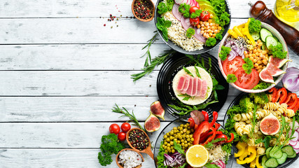 Set of dishes on the table. Rice, lentils, chickpeas, meat and fish. Dishes menu. Free copy space. Top view.