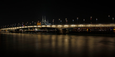 Naklejka na ściany i meble Cologne a city on the Rhine at night as a skyline