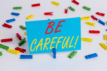 Text sign showing Be Careful. Business photo text making sure of avoiding potential danger mishap or harm Colored clothespin papers empty reminder white floor background office