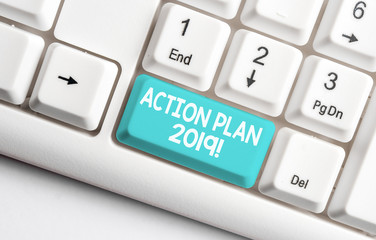 Conceptual hand writing showing Action Plan 2019. Concept meaning proposed strategy or course of actions for current year White pc keyboard with note paper above the white background