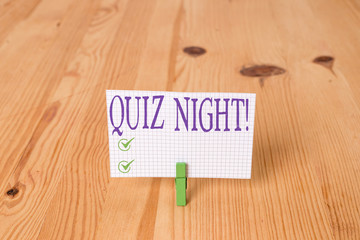 Writing note showing Quiz Night. Business concept for evening test knowledge competition between individuals Wooden floor background green clothespin groove slot office