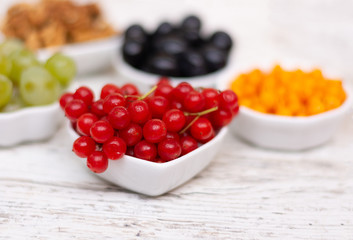 Viburnum closeup on a white table with a blurred background. Vitamins of Autumn. Place for the test, Copy space