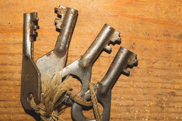 Bunch of old keys isolated on wooden background