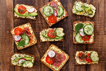 Sandwiches with cream cheese, vegetables and salami.