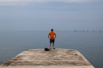 Man on pier on the sea 