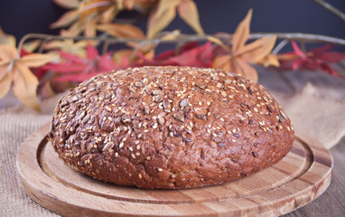 freshly baked bread on wooden kitchen table in autumn style