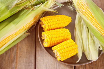 Boiled sweet corn on a plate. Top view.