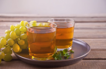 Gug and glasses of grape juice on the old wooden table