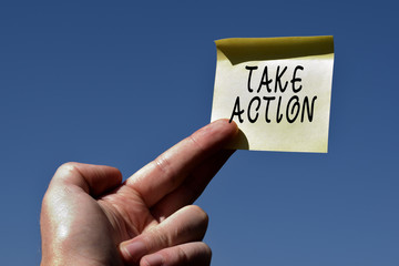 Conceptual hand writing showing Take Action. Concept meaning to do somethingoract in order to get a particular result Square paper piece notation stick to textured glass window