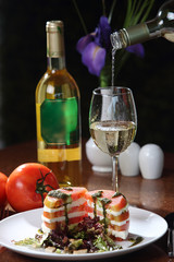 Tomato salad with goat cheese, lettuce and purple cabbage.