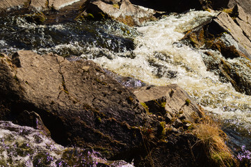 Waterfall background. rushing stream water. rocky flowing river