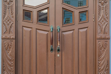 Close-up of wooden door with carving