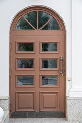 Arched wooden door with glass