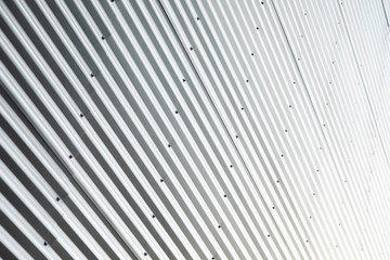 Building with ribbed metal wall in sun