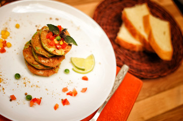 Squash fritters served on a plate and whole grain bread