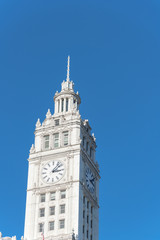 Fototapeta na wymiar Lookup view of typical skyline building with rooftop tower clock in Chicago downtown