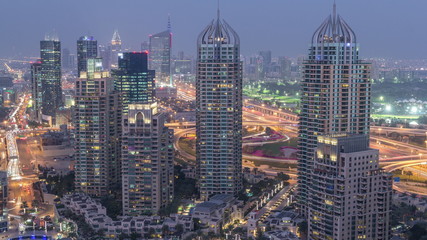 Aerial top view of Dubai Marina day to night timelapse. Modern towers and traffic on the road