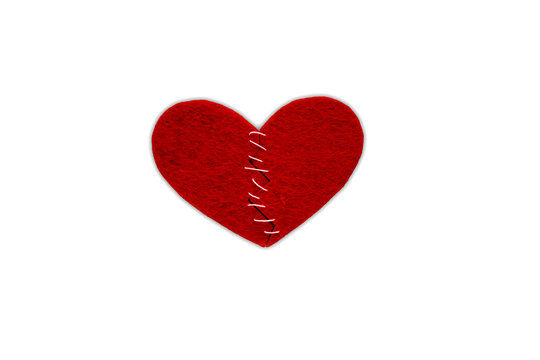 Red heart fabric with white threads on white background, isolated. The concept of Sadness, unhappy love, broken heart.
