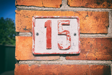 Street number 15 on a sign