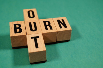 Burnout Word Written In Wooden Cube. Burn out, cube with letters. dice with text. concept of the...