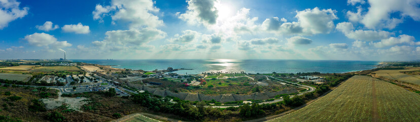 Obraz premium Aerial view of the ruins of the Roman Amphitheater in the sand dunes of the ancient city of Caesarea Maritima built by Herod the Great 