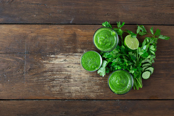 Detox diet concept. Green smoothie on a wooden background top view