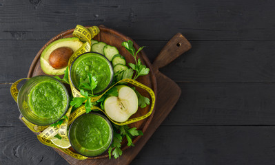 Green detox smoothie with measuring tape detox top view diet concept