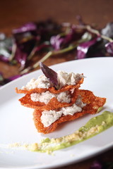 Chicharrón enchilado with goat cheese and avocado sauce.