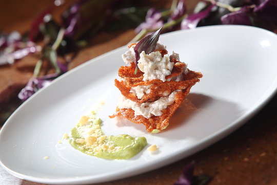 Chicharr&oacute;n enchilado with goat cheese and avocado sauce.
