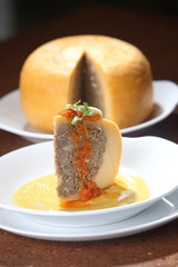Edam cheese stuffed with beef stew with tomato sauce and hard-boiled egg.