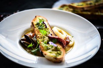 tasty seafood soup with fresh vegetables - shrimps, shells, octopus and crispy home made bread
